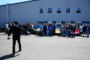 Factory Five Racing headquarters exterior with tour group