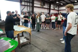 Visitors in Factory Five workshop learning about roadster kits