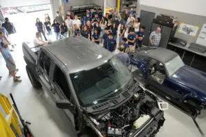 Visitors inspecting a Factory Five custom build in the warehouse