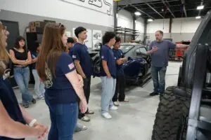 Factory Five Racing staff giving guided tour to students