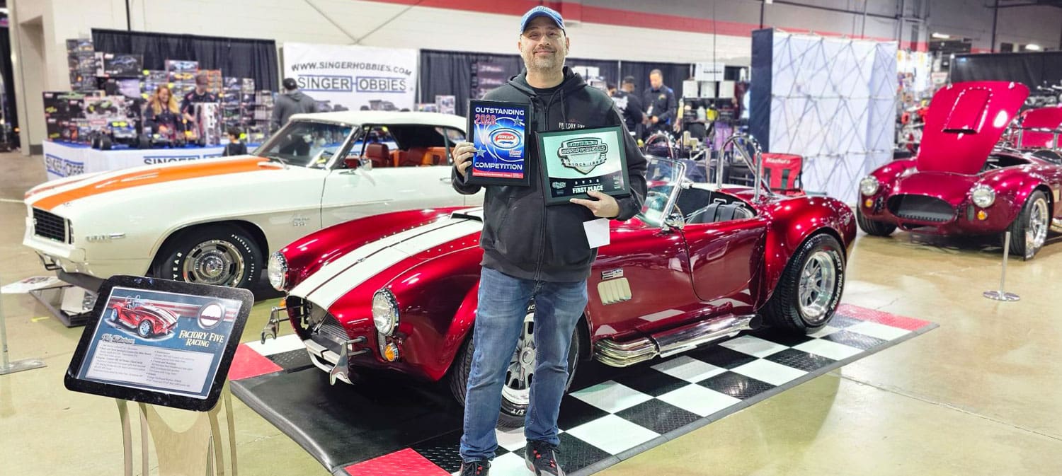 Builder holding awards with MK4 Roadster