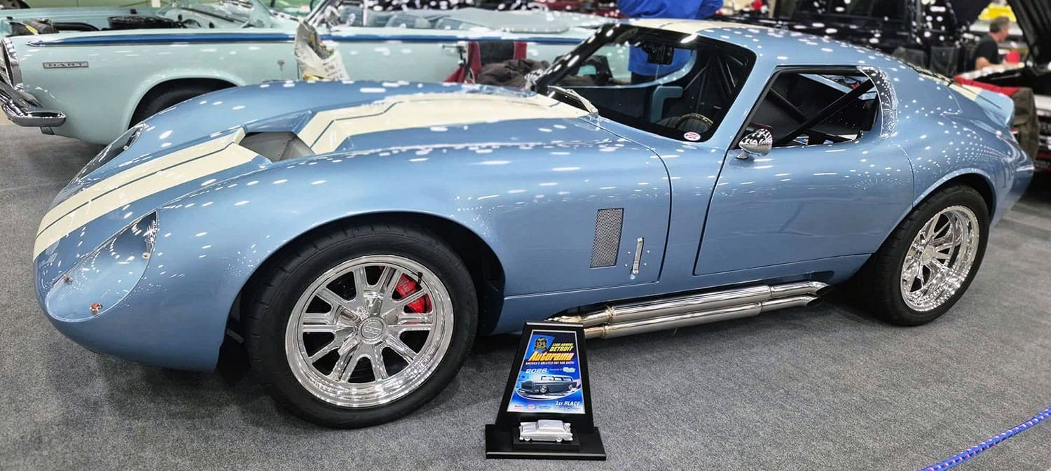 Blue Type 65 Coupe side with award