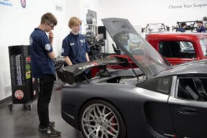 Factory Five GTM supercar with doors open in showroom