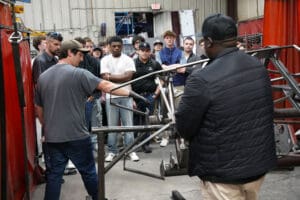 Engineer walking visitors through MK5 Roadster chassis build