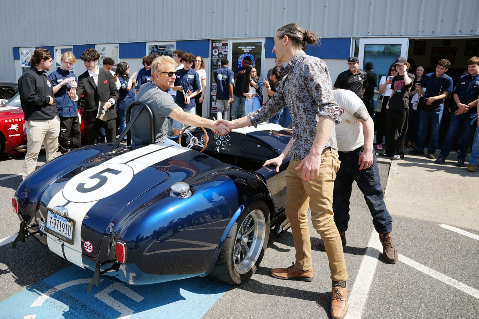 Blue Factory Five Cobra roadster with white racing stripes