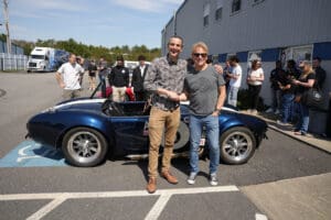 Two men take picture with Factory Five Cobra roadster
