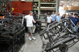 Engineer demonstrating MK5 Roadster tubular space frame chassis